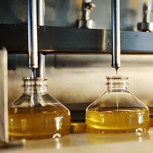 Filling amber bottles with natural liquid Castile soap in Türkiye.